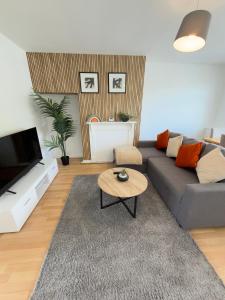 a living room with a couch and a coffee table at Contractor & Family Haven, Sleeps 7, Parking & Garden in Wednesfield