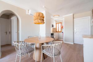 a kitchen and dining room with a table and chairs at CARABELA 93 in Alcudia