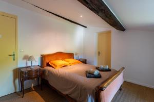 a bedroom with a bed with yellow pillows at Bastide de Marius in Redortiers +37 photos