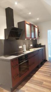 a kitchen with a stove and a counter top at Ferienwohnung an der Holtemme in Derenburg