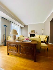 a living room with a couch and a table at L'escale vosgienne in Saint Die