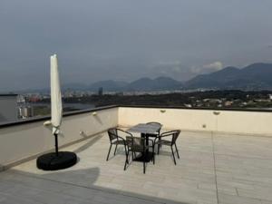 a patio with a table and chairs on a roof at Tirana Panoramic view in Sauk