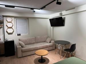 a living room with a couch and a table at Tirana Panoramic view in Sauk