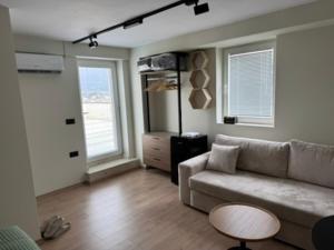 a living room with a couch and a table at Tirana Panoramic view in Sauk