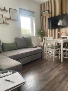a living room with a couch and a table at Offline vendégház in Orfű