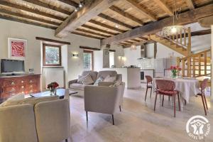 a living room with a couch and a table at Le gué de brocéliande in Plélan-le-Grand