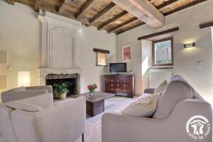 a living room with couches and a fireplace at Le gué de brocéliande in Plélan-le-Grand