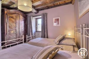 a bedroom with two beds and a window at Le gué de brocéliande in Plélan-le-Grand