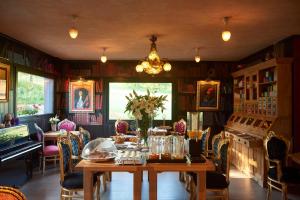 a dining room with a table and chairs at Hôtel Le Manoir des Montagnes in Les Rousses