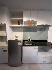 a small kitchen with a sink and a refrigerator at The Pixel Sri Panwa, Phuket in Ban Ao Makham +8 photos