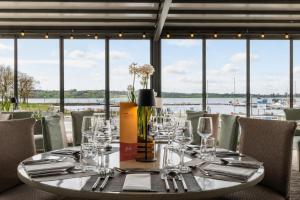 a table in a restaurant with a view of the water at Lakeside Manor Hotel in Virginia +25 photos