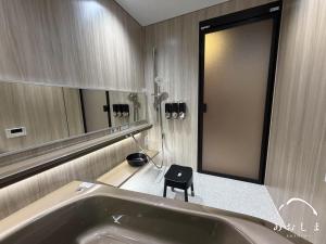 a bathroom with a sink and a stool next to a mirror at Aoshima あおしま in Kameshima +24 photos