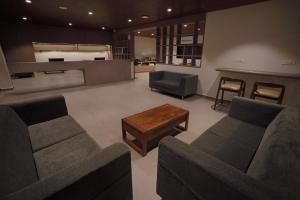 a large living room with two couches and a table at Hotel Jubilee Park- Kondapur in Hyderabad +41 photos
