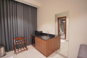a hotel room with a sink and a bathroom at Hotel Jubilee Park- Kondapur in Hyderabad