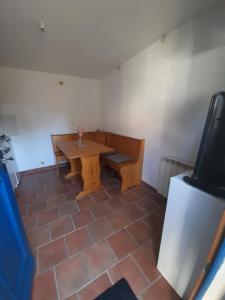 a room with a wooden table and a tv at Studio in Isigny-sur-Mer