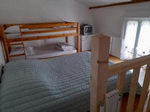 a bedroom with two bunk beds and a window at Studio in Isigny-sur-Mer