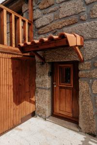 a wooden door on the side of a stone building at Casa Ti Nogueira in Soajo
