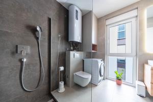 a bathroom with a shower and a toilet and a window at Premium Šimuni by Pag tours in Šimuni +33 photos