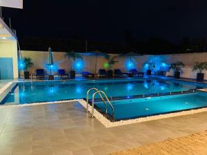 a swimming pool at night with blue lights at The Ocean Pearl Hotel Negombo in Negombo