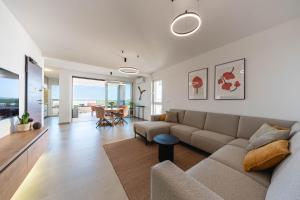 a living room with a couch and a table at Premium Šimuni by Pag tours in Šimuni