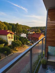 a view of a town from a balcony at Artystyczny Picasso apartament z widokiem na jezioro i tarasem in Charzykowy