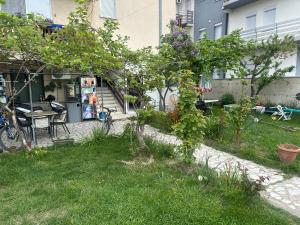 a garden in front of a building with a table at Camping Struga Macedonia in Struga +79 photos