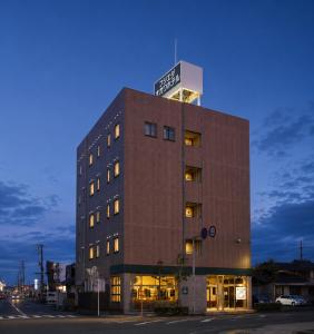 a building with a sign on the top of it at Fujieda Ogawa Hotel フジエダオガワホテル in Fujieda