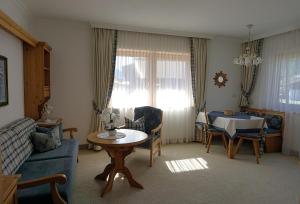 a living room with a couch and a table at Landhaus Achental in Pertisau