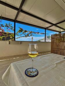 a glass of wine sitting on a table at Apartments Adriatic Nest in Omiš