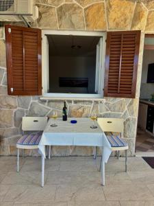 a white table with two chairs and a window at Apartments Adriatic Nest in Omiš +19 photos