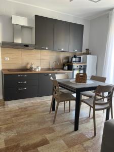 a kitchen with a table and chairs in a room at Vittorino house in Polignano a Mare