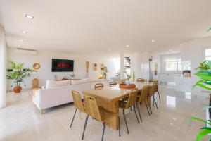 a living room with a table and a white couch at Beach Villa with ocean view in Lourinhã