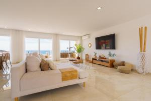 a living room with a white couch and a table at Beach Villa with ocean view in Lourinhã