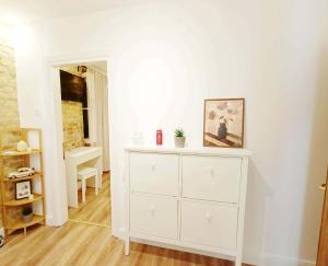 a white dresser in a room with a mirror at Fiore Kampielo Apartment in Corfu