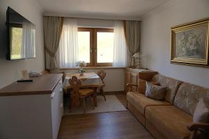a living room with a couch and a table at Landhaus Achental in Pertisau