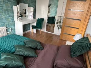 a bedroom with a bed and a couch and a table at Cimmele Apartment in Sigulda
