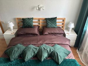 a bedroom with a large bed with two night stands at Cimmele Apartment in Sigulda
