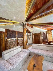 a living room with a couch and a ceiling fan at Forest Home 2 in Železnička Stanica )) (( Gornja Plavnica +31 photos