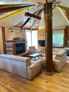 a large living room with a couch and a tv at Forest Home 2 in Železnička Stanica )) (( Gornja Plavnica