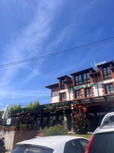 a building with cars parked in front of it at hosteria de Boo in Boó de Piélagos