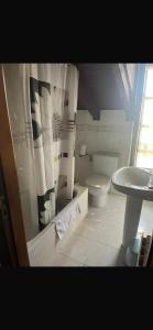 a bathroom with a toilet and a sink at hosteria de Boo in Boó de Piélagos