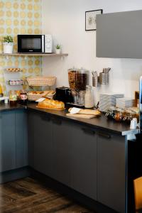eine Küche mit einer Arbeitsfläche, auf der Lebensmittel stehen in der Unterkunft Hôtel Alcôve Nice in Nizza