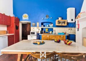 a kitchen with a table with bowls of fruit on it at MyStay - Monte dos Abrunhos in Vimieiro