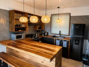 a kitchen with a wooden counter top and a refrigerator at Casita Don Marco in Bocas Town