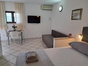 a living room with a couch and a table at Apartments Rose in Stanići