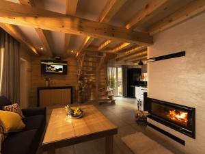 a living room with a couch and a fireplace at Domki nad Zaporą w centrum Soliny przy Zaporze - wybrane domki z jacuzzi in Solina