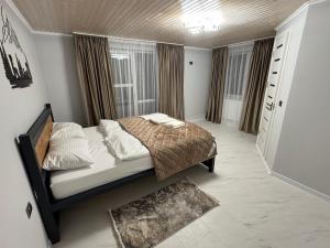 a bedroom with a bed in a room at Vista Guest House in Yaremche