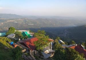 an aerial view of a house on a mountain at Mughal E Azam Hotel in Murree +32 photos