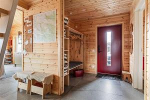 a wooden cabin with a red door and a room with bunk beds at Tännstoppet - Tänndalen in Tänndalen +13 photos