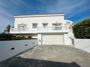 a large white house with a white garage at Villa El Dorado in Estepona